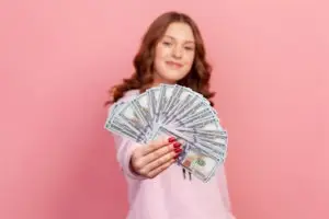 excited person holding american dollars