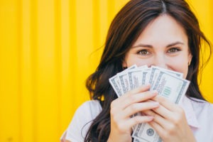 young woman holding money