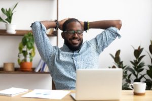 carefree man smiling at computer