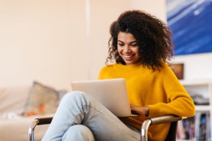 woman on laptop just received good news about loan