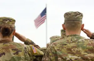 American soldiers saluting US flag