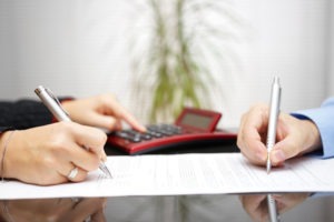 attorney calculating expenses with a client