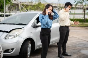 two people calling for help after a crash