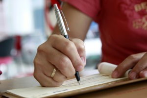 woman signing a check