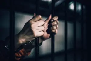 prisoner-holding-onto-cell-bars