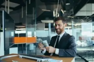 businessman happily counting cash