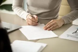 woman filling out loan paperwork