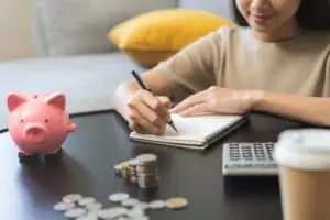 woman taking note of her finances