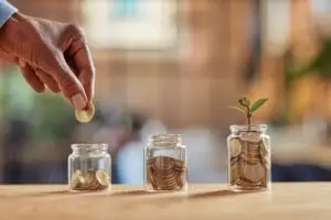 woman adding coins to jars