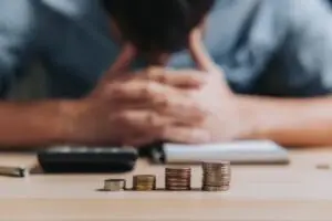 man with coins planning his budget