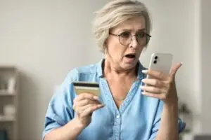 woman on phone shocked to see her loan was approved