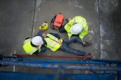 a-construction-worker-receiving-medical-attention-at-a-job-site-after-suffering-a-work-accident