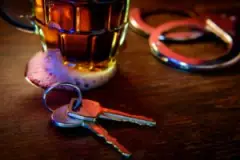 car-keys-and-handcuffs-by-a-glass-of-beer