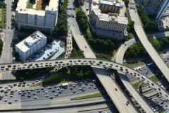 An aerial view shows a group of highway lanes merging. Who is at fault in a merging accident