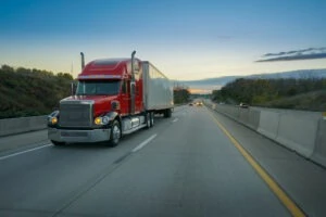 A big red semi-truck. You can contact a semi-truck accident lawyer after a collision with a commercial vehicle.