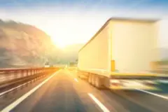 blurred image of an 18-wheeler speeding on the highway