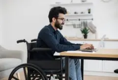 man in wheelchair doing work