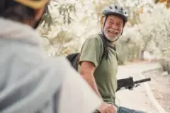 smiling older man on bike