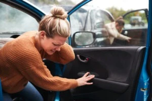 A woman gets out of her car and wonders what she should do if she’s been injured in a drunk driving accident.