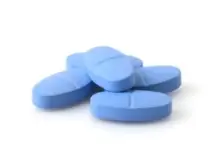 Five blue pills all in a pile together