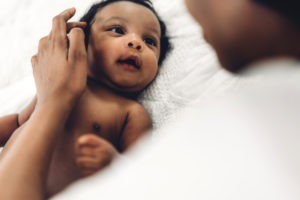 black baby looking up at their mom