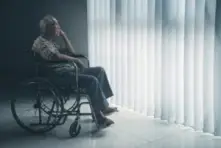 elderly Asian man sitting in a wheelchair