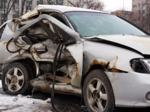 flattened white car after an accident