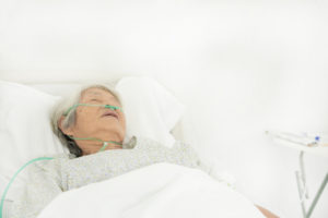 older woman lying in a hospital bed