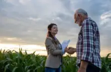 A man speaking with an insurance claims representative showing that we handle Farmers Insurance claims in Ohio