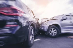 a blurred image of two SUVs colliding on the road