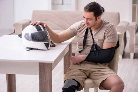 Young male motor-cyclist suffering at home after accident.