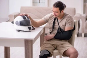 Young male motor-cyclist suffering at home after accident.