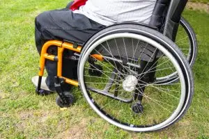 A person with a disability sits in a wheelchair.