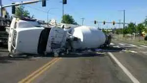 A cement truck is getting hauled away after a crash near the freeway.