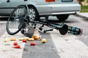 bike lying in street after being struck by car