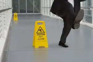 businessman slips on wet floor in hallway 