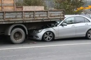 car crashed into back of large truck