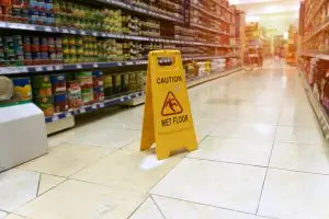 wet floor sign in supermarket aisle