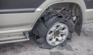 A shredded tire after an accident.