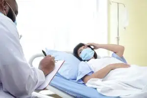 doctor taking a female patient’s vitals