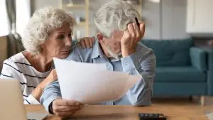 elderly couple struggles with paperwork