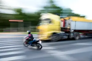 speeding-truck about to hit motorcyclist 