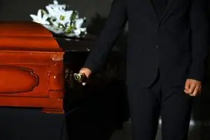 men carrying wooden casket
