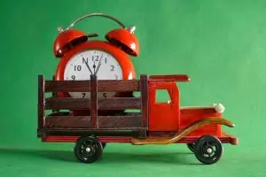 model truck with alarm clock in its bed