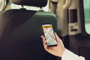 woman using rideshare app in car