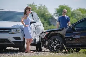 man and woman dealing with a car accident