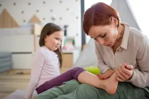 mother inspecting daughter’s foot