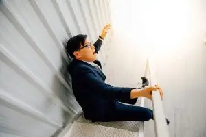 asian man falling on stairs