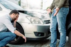 men arguing after a car accident