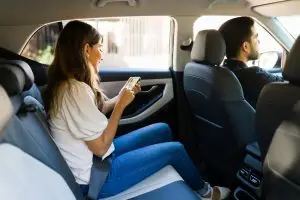 woman sitting in the back of a rideshare car